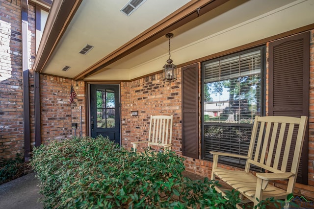 view of exterior entry with a porch