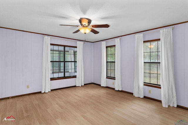 empty room with ceiling fan, light hardwood / wood-style floors, and ornamental molding