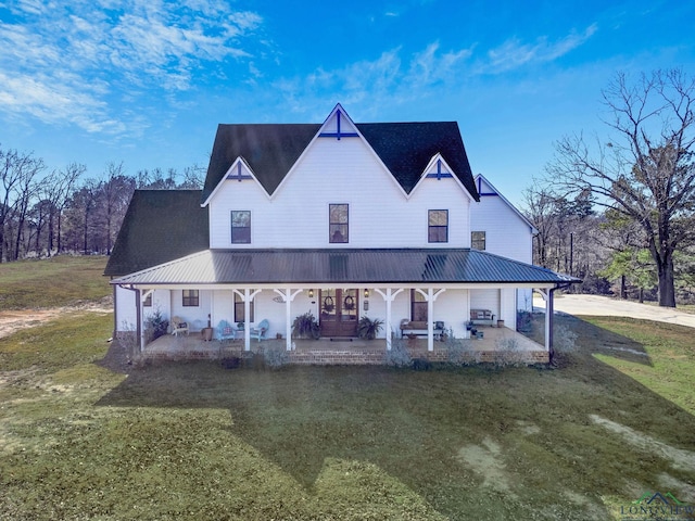 view of front of home featuring covered porch, a front lawn, and a patio