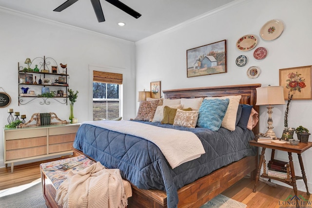 bedroom featuring hardwood / wood-style flooring, ceiling fan, and crown molding