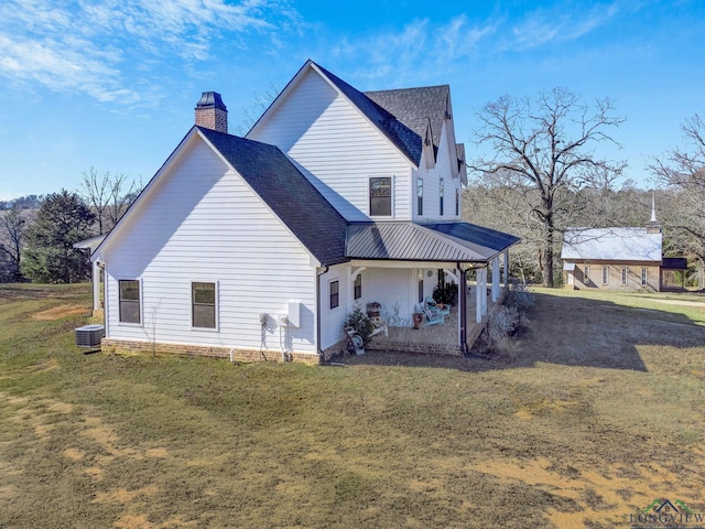 view of property exterior featuring cooling unit and a yard