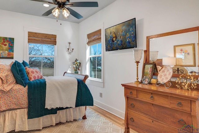 bedroom with ceiling fan and light hardwood / wood-style floors