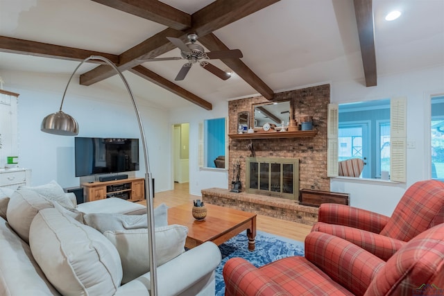 1015 Bel Air Dr, Athens, TX 75751 - living area featuring wood finished floors, a ceiling fan, beam ceiling, and a fireplace