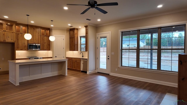 kitchen featuring stainless steel appliances, light countertops, a sink, and backsplash