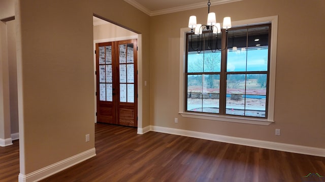 interior space with french doors, an inviting chandelier, dark wood-type flooring, ornamental molding, and baseboards