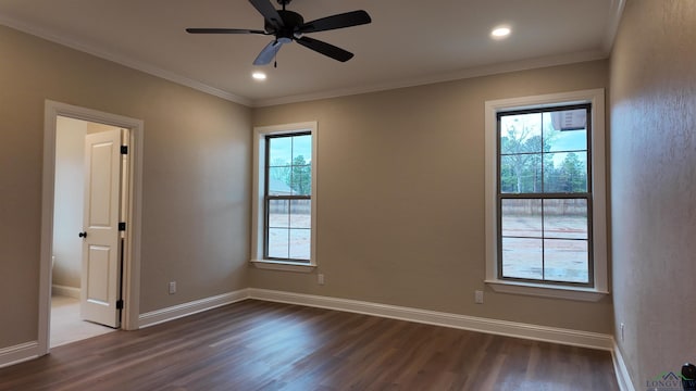 unfurnished room featuring ornamental molding, dark wood finished floors, and baseboards