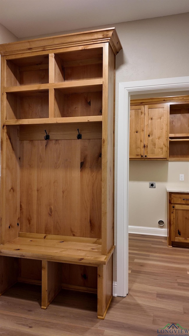 mudroom with baseboards and wood finished floors