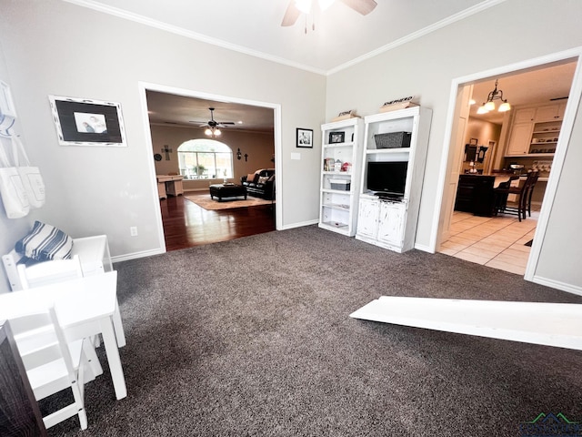 carpeted living room with ceiling fan with notable chandelier and ornamental molding