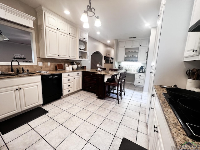 kitchen featuring light stone countertops, sink, black appliances, white cabinets, and hanging light fixtures