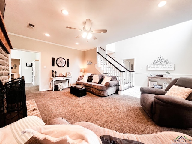 carpeted living room with ceiling fan and crown molding