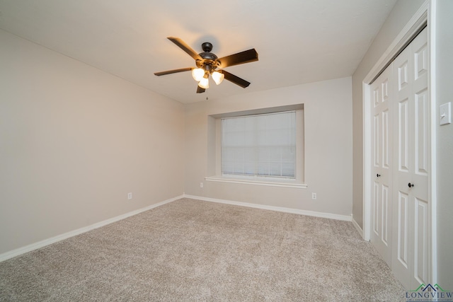 unfurnished room with ceiling fan and carpet flooring