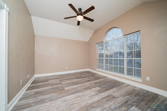 spare room featuring light wood-type flooring, ceiling fan, and lofted ceiling