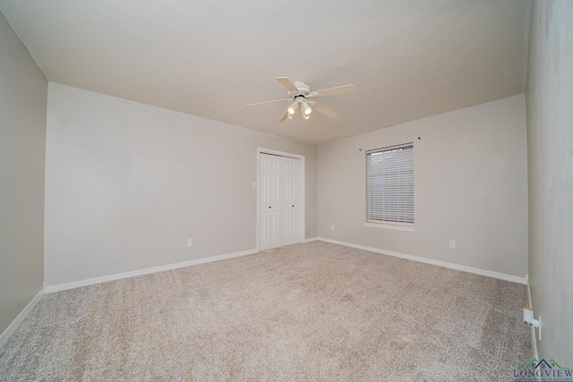 empty room with ceiling fan and carpet