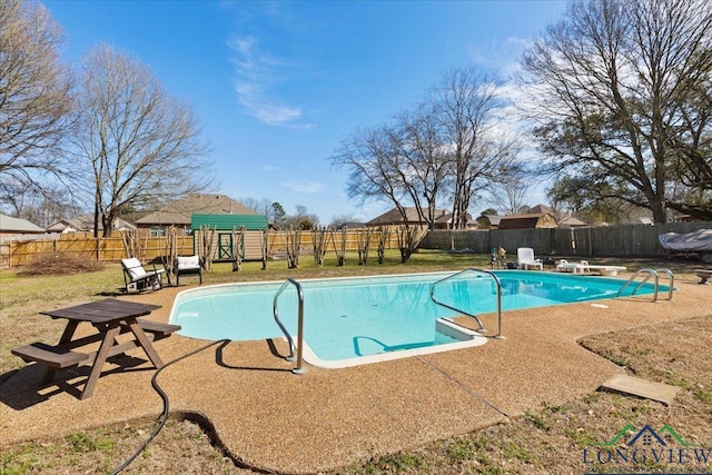 view of pool featuring a patio, a lawn, a fenced backyard, and a fenced in pool