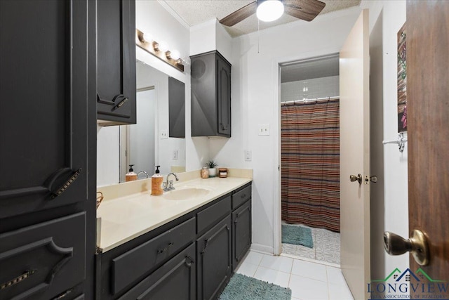 bathroom featuring ceiling fan, vanity, tile patterned floors, a textured ceiling, and crown molding