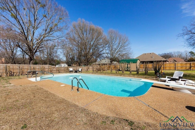 view of swimming pool with a fenced in pool, a patio area, a fenced backyard, and a diving board