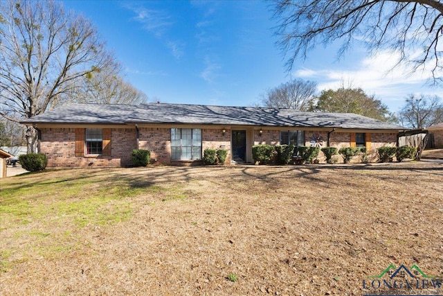 ranch-style house with brick siding and a front lawn