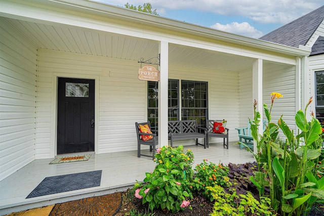 view of exterior entry with a porch