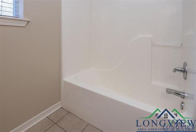 full bathroom featuring tub / shower combination, tile patterned floors, and baseboards