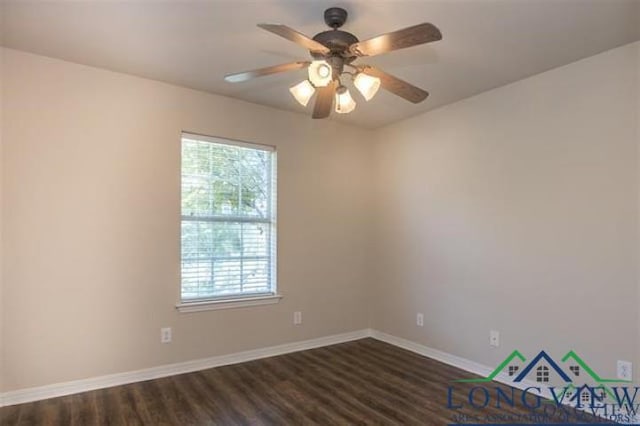 unfurnished room featuring dark wood finished floors, a ceiling fan, and baseboards