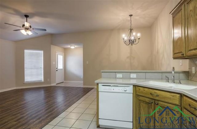 kitchen with dishwasher, ceiling fan with notable chandelier, open floor plan, and a sink