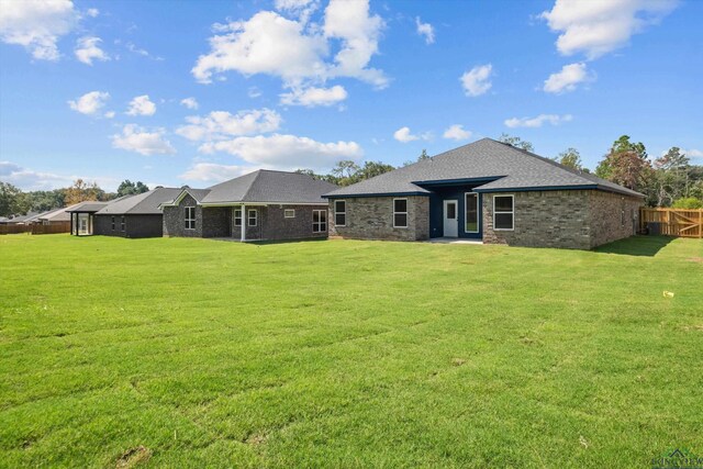 back of house with a lawn