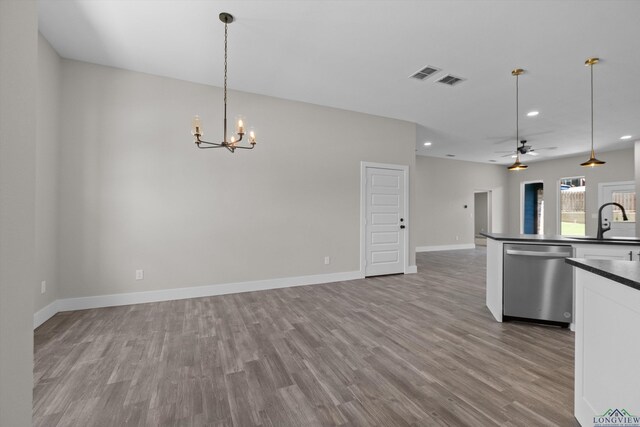 kitchen with ceiling fan with notable chandelier, pendant lighting, dishwasher, sink, and light wood-type flooring