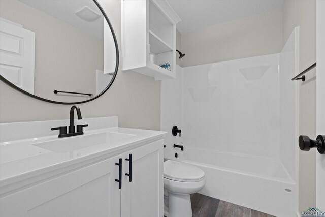 full bathroom featuring vanity, toilet,  shower combination, and wood-type flooring