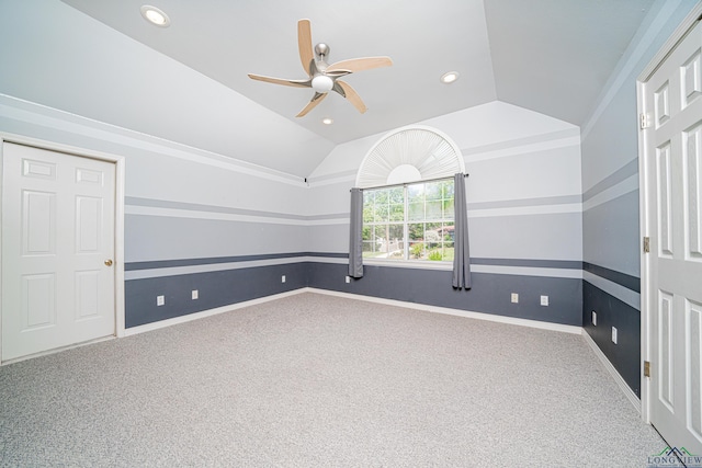 unfurnished room with carpet, ceiling fan, and vaulted ceiling