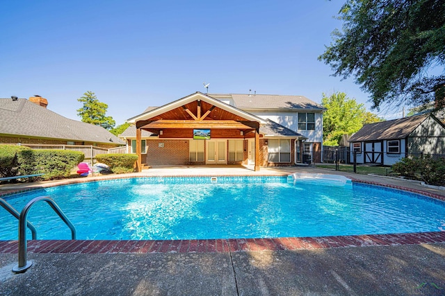 view of pool with an outdoor structure