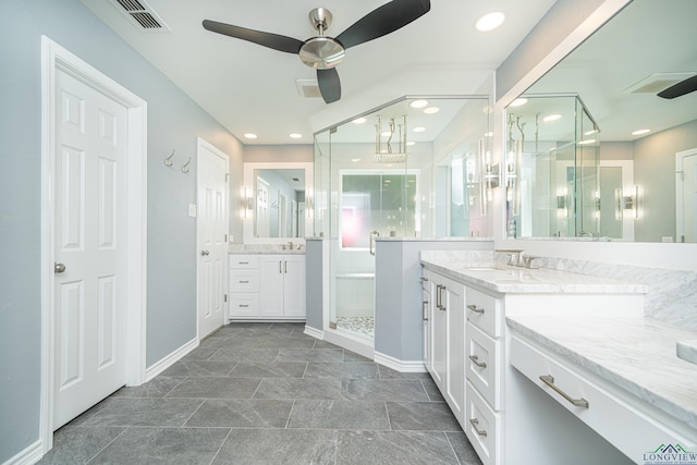 bathroom featuring ceiling fan, vanity, and a shower with shower door