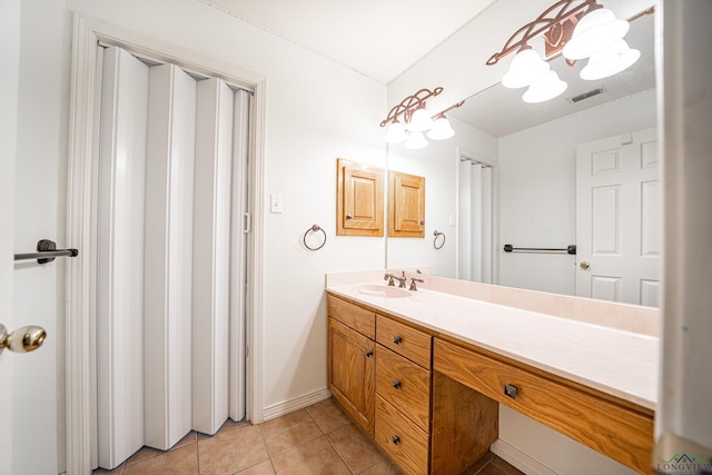 bathroom with tile patterned flooring and vanity