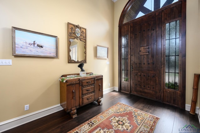 entryway featuring dark wood-style flooring and baseboards