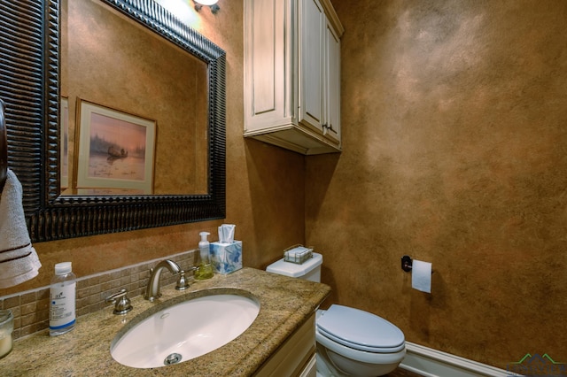 bathroom with toilet and vanity