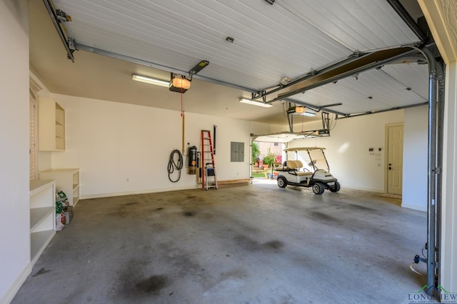 garage featuring electric panel, baseboards, and a garage door opener