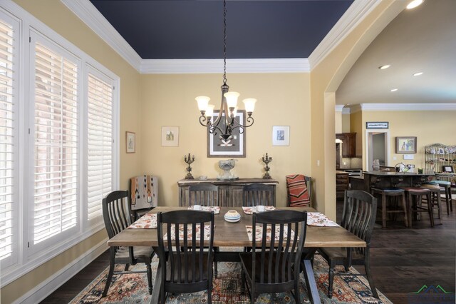 dining area featuring a wealth of natural light, baseboards, a chandelier, and dark wood finished floors