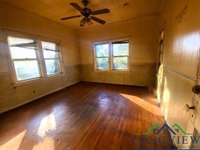 empty room with dark hardwood / wood-style floors and ceiling fan