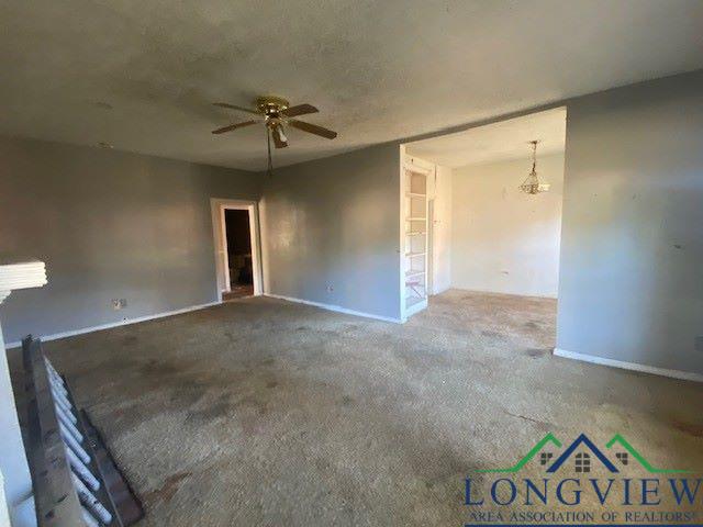 spare room with ceiling fan and carpet floors