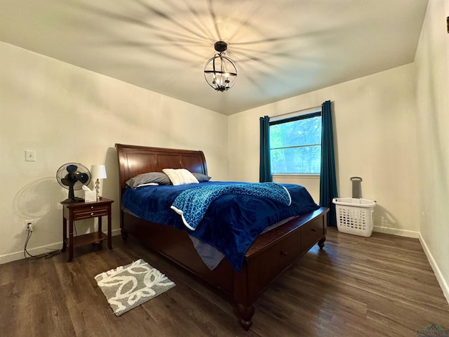 1612 Oden St, Longview, TX 75602 - bedroom featuring wood finished floors, baseboards, and a chandelier