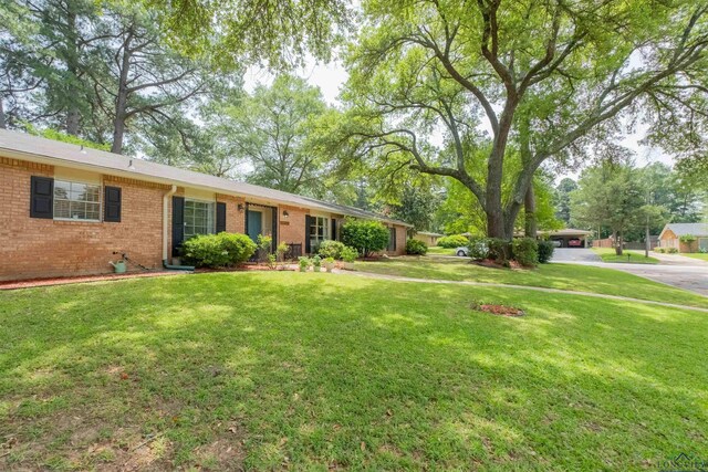1900 Franklin Dr, Longview, TX 75601 - view of front of property featuring brick siding and a front lawn