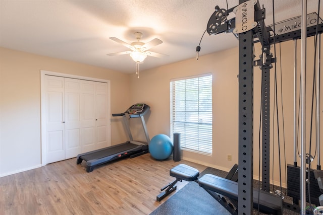 1900 Franklin Dr, Longview, TX 75601 - exercise room featuring wood finished floors, a ceiling fan, and baseboards