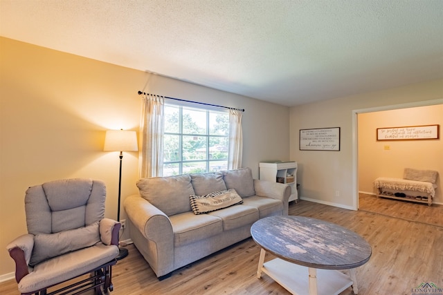 1900 Franklin Dr, Longview, TX 75601 - living area with light wood-type flooring, a textured ceiling, and baseboards