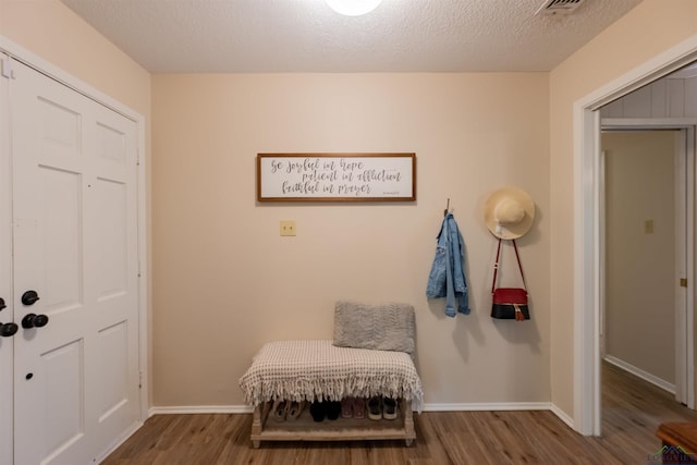 1900 Franklin Dr, Longview, TX 75601 - entryway with wood finished floors, baseboards, and a textured ceiling