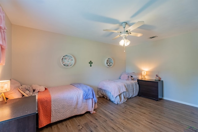 1900 Franklin Dr, Longview, TX 75601 - bedroom with wood finished floors, a ceiling fan, and baseboards