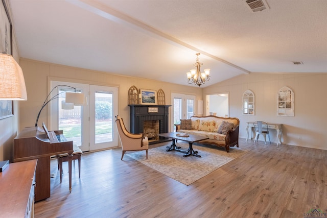 1900 Franklin Dr, Longview, TX 75601 - living area featuring wood finished floors, a chandelier, and a brick fireplace