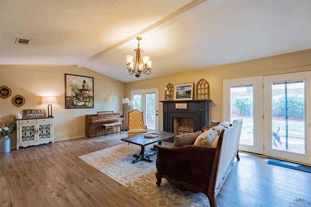 1900 Franklin Dr, Longview, TX 75601 - living room featuring wood finished floors, a chandelier, a fireplace, and baseboards