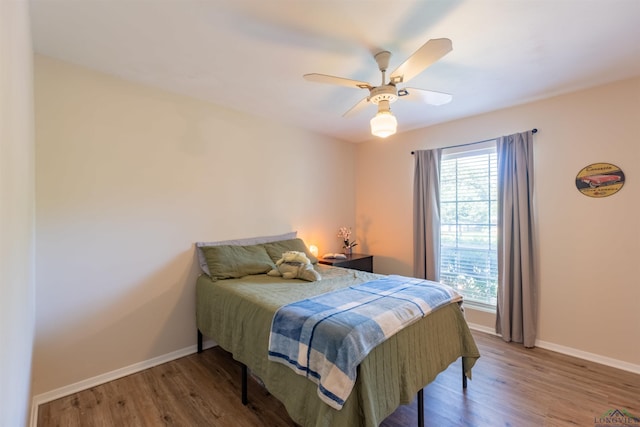 1900 Franklin Dr, Longview, TX 75601 - bedroom with baseboards, wood finished floors, and ceiling fan