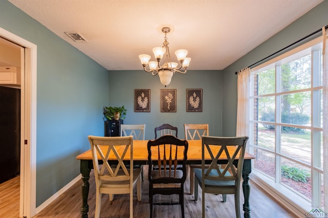 1900 Franklin Dr, Longview, TX 75601 - dining area with a chandelier, wood finished floors, and baseboards