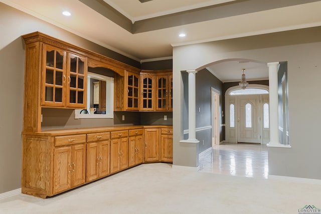 bar featuring crown molding and decorative columns