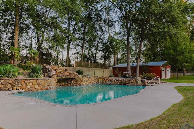 view of pool featuring a patio area and an outdoor structure